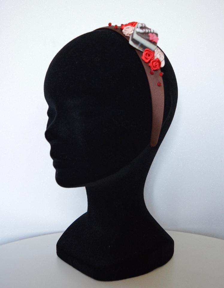 IMAGE - Brown satin headband with cake, red and cream ribbon roses and red beads.