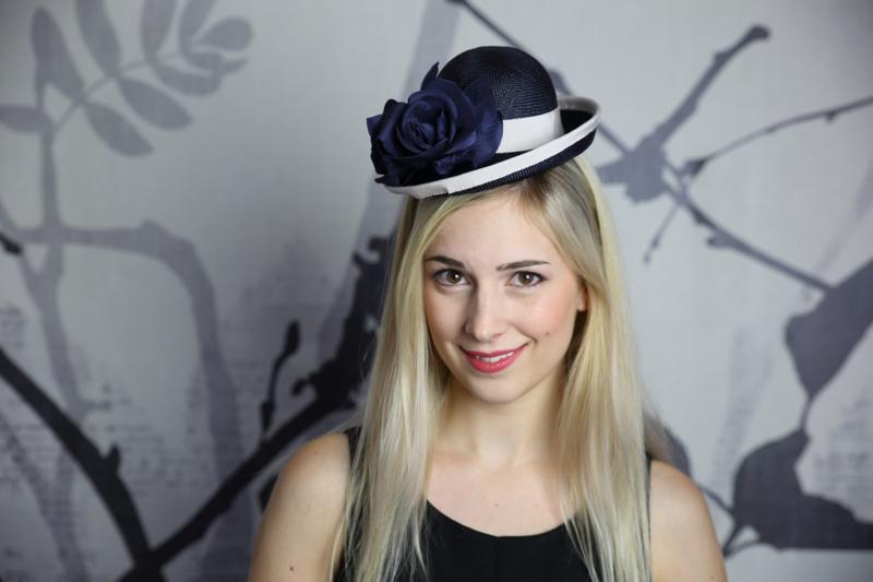 IMAGE - Hand blocked navy straw hat, finished with light grey ribbon and navy silk rose.
Fixes with and elastic