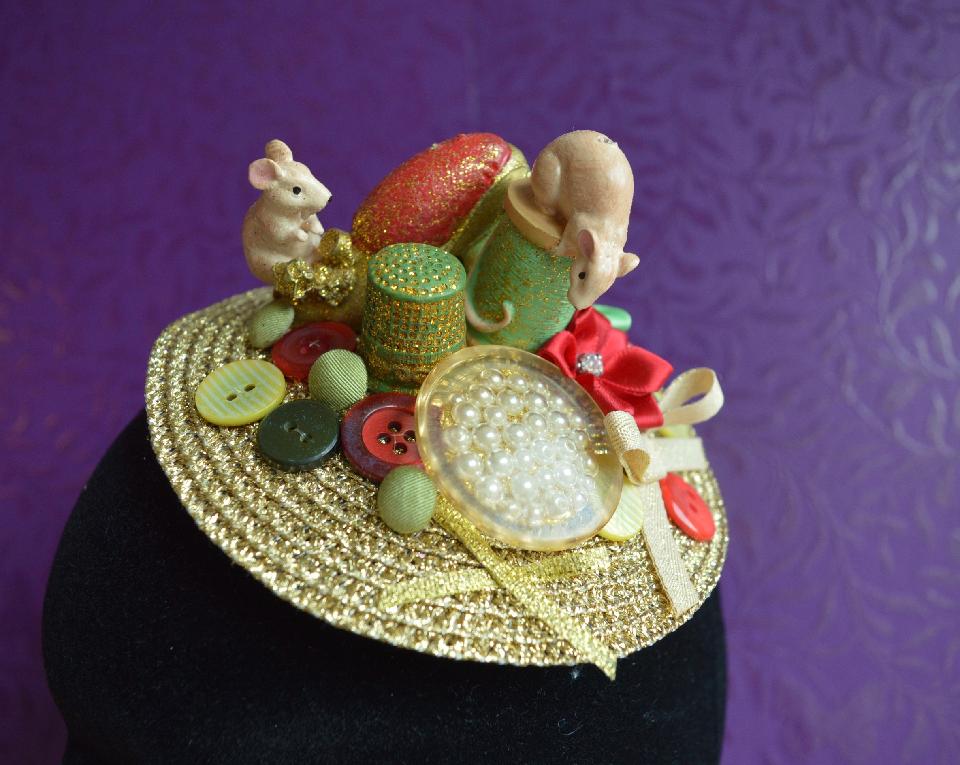 IMAGE - Gold straw fascinator decorated with sewing mice, and buttons in various shades of gold, green and red. Fixes to hair with a comb.