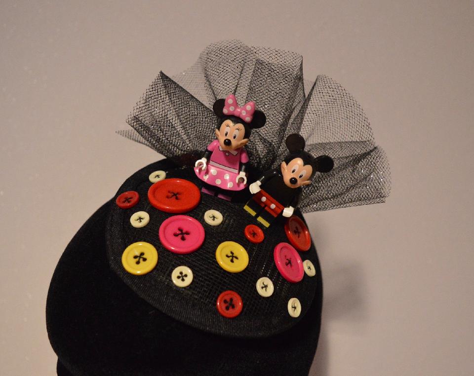 IMAGE - Small black sinamay fascinator with black glittered tulle, Mickey and Minnie and buttons. Fixes to hair with a comb.
