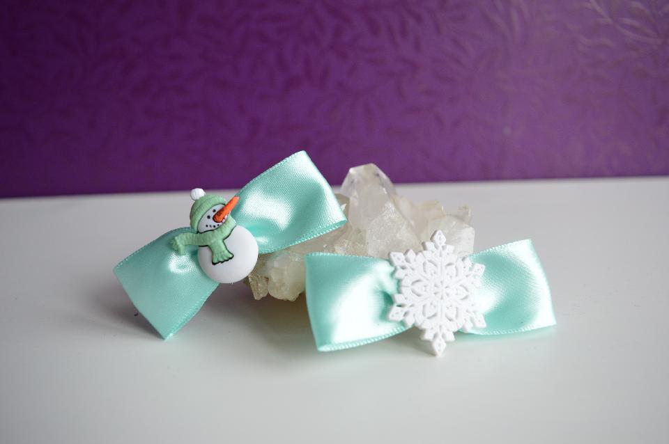 IMAGE - Set of two light blue satin bow hairpins with snowman and snowflake.