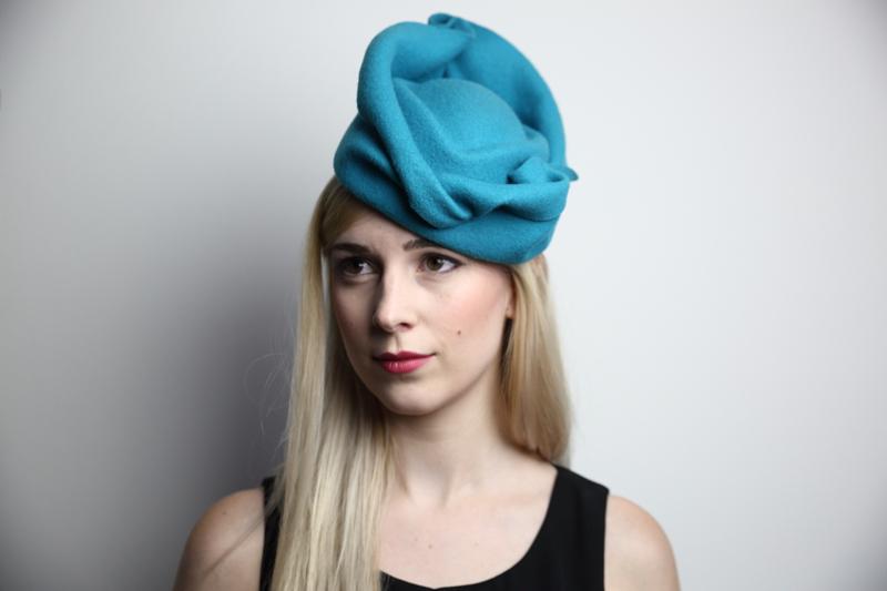 IMAGE - Handblocked teal woolfelt hat with handshaped brim. 
This on is a small size, so there is a thin metal headband to help it stay on.