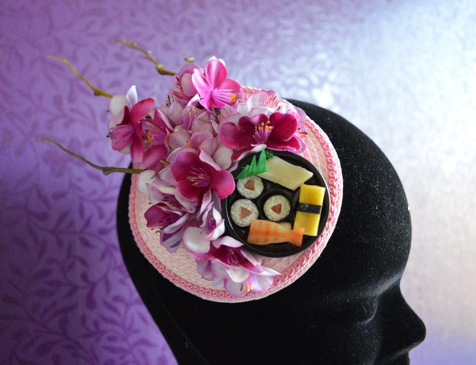 IMAGE - Pink straw fascinator with sushi plate and cherry blossoms. Fixes to hair with a comb.
